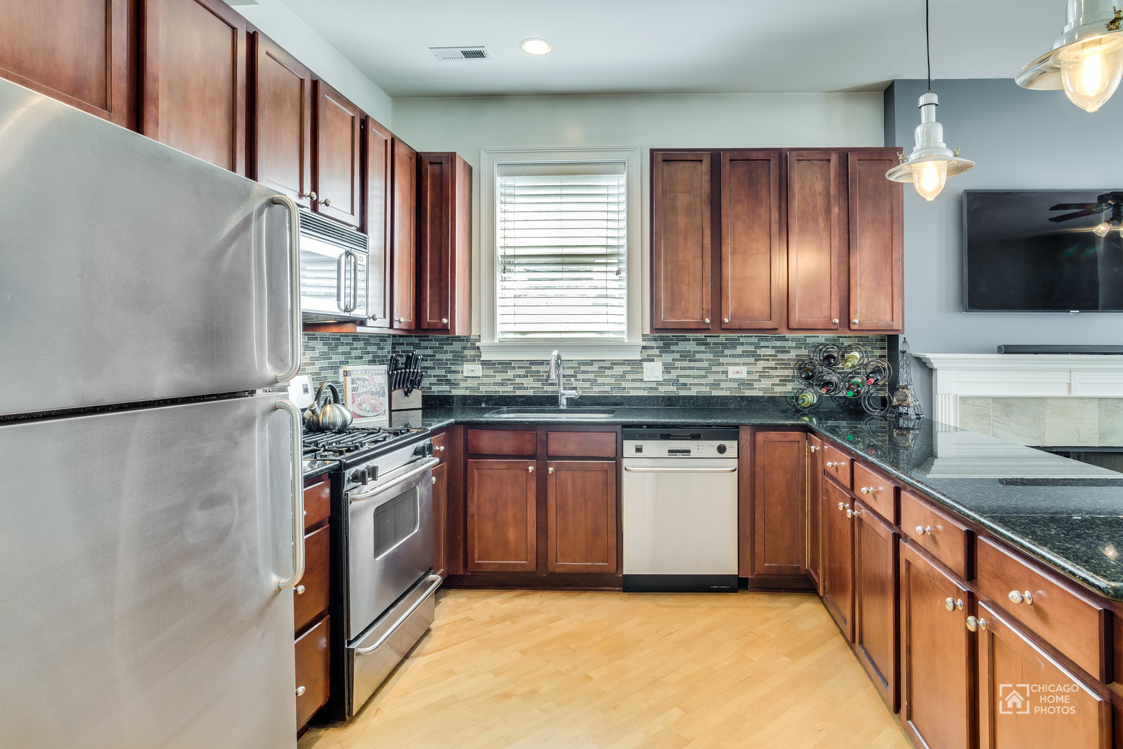 2128 West Walton Street, Unit 2E Chicago, IL 60622 - Photo 9 of 23 a kitchen with stainless steel appliances granite countertop a stove a sink and a refrigerator