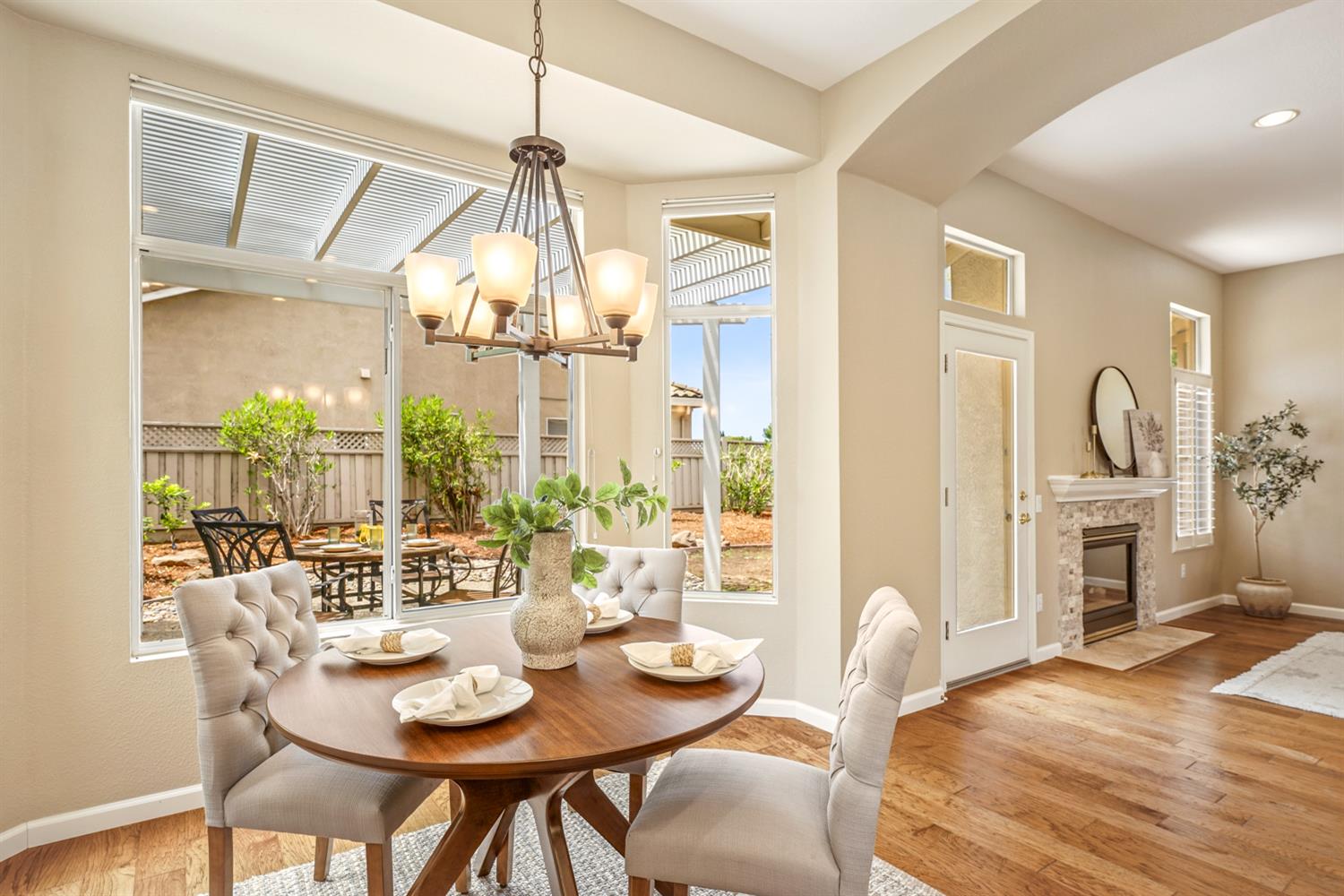 4081 Rose Creek Road Roseville, CA 95747 - Photo 15 of 52 a dining room with furniture a chandelier and wooden floor