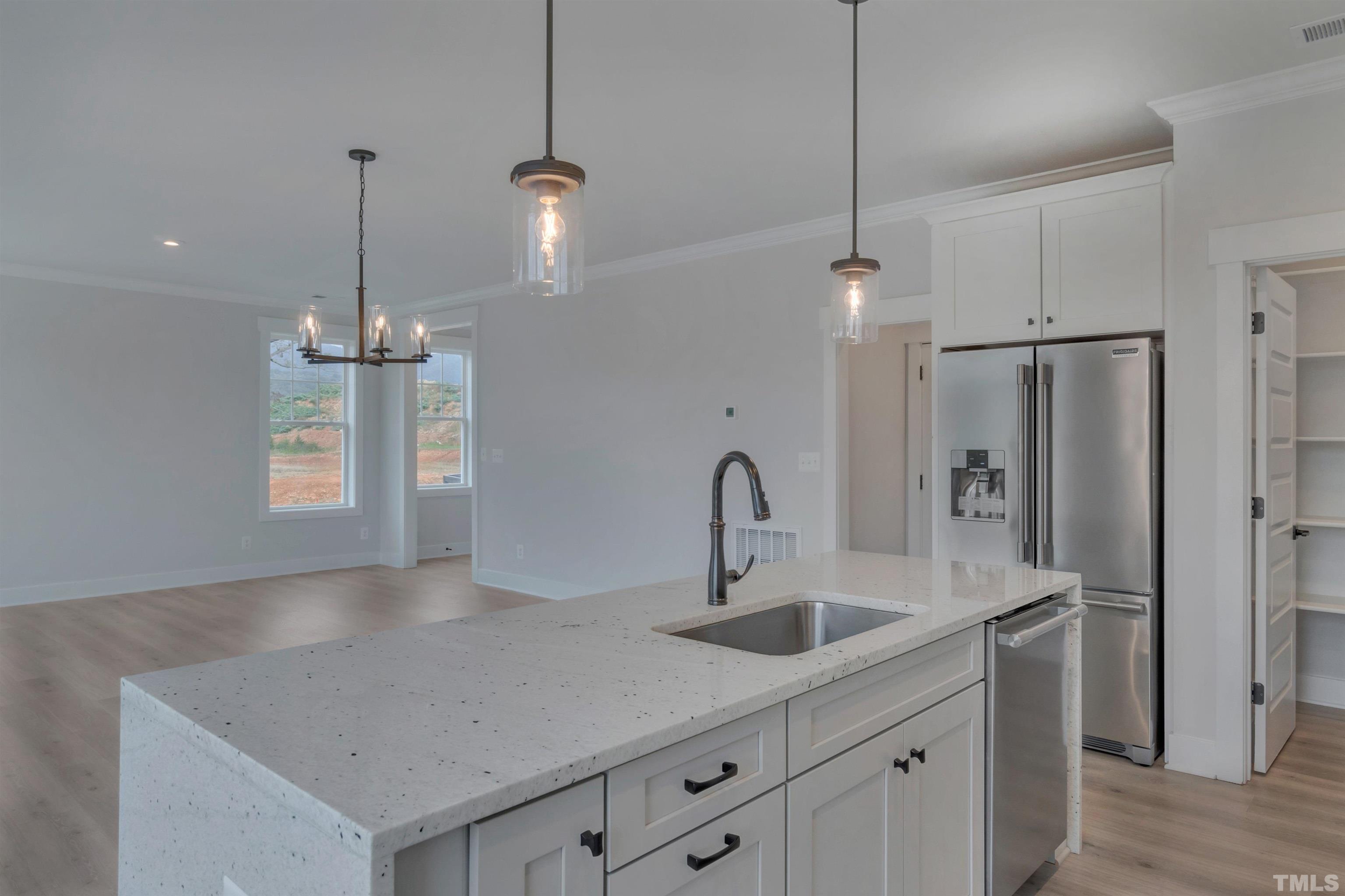 159 Dunloe Loop Raleigh, NC 27603 - Photo 3 of 19 a kitchen with stainless steel appliances a sink a refrigerator a center island a stove and a sink
