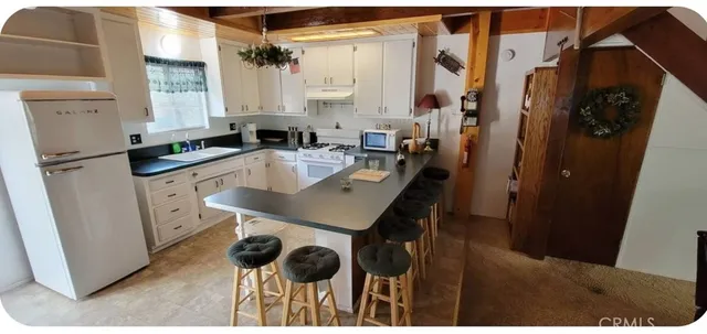 a kitchen with a sink a refrigerator a stove a washer and dryer