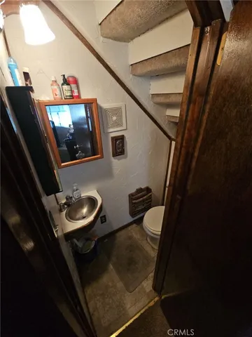 a living room with furniture and a mirror