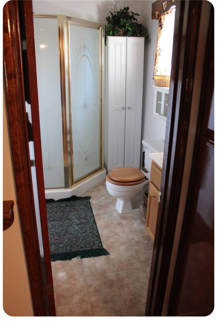 33076 Robin Lane Running Springs, CA 92382 - Photo 10 of 10 a bathroom with a granite countertop sink and a mirror
