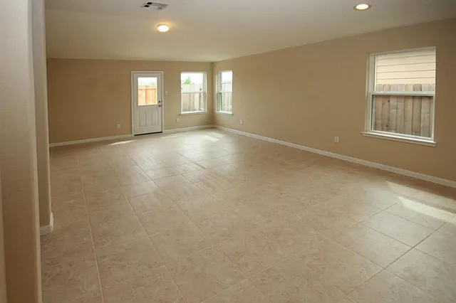 an empty room with windows and entrance