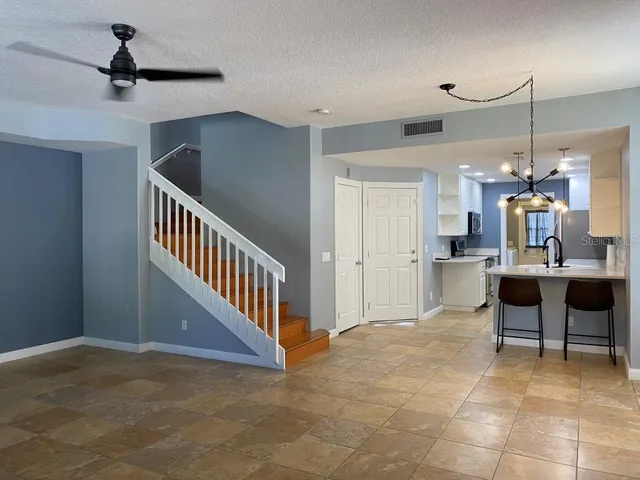 a view of a livingroom with furniture and staircase