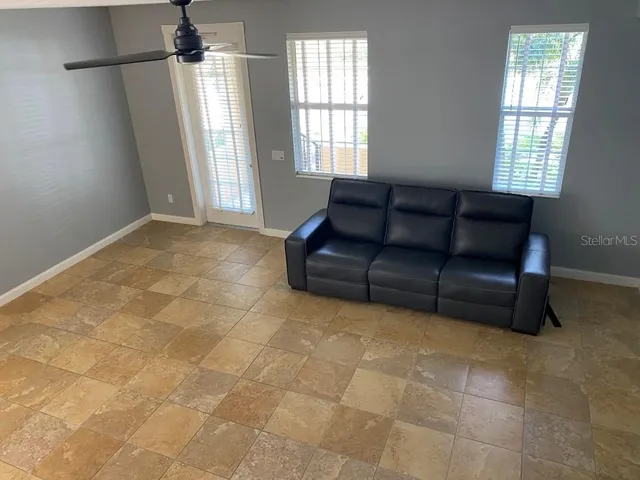 a living room with a couch and a window
