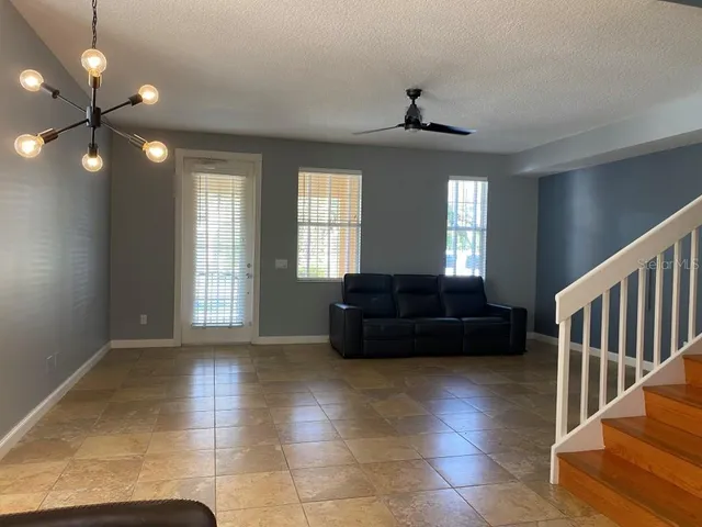 a living room with a couch and a chandelier