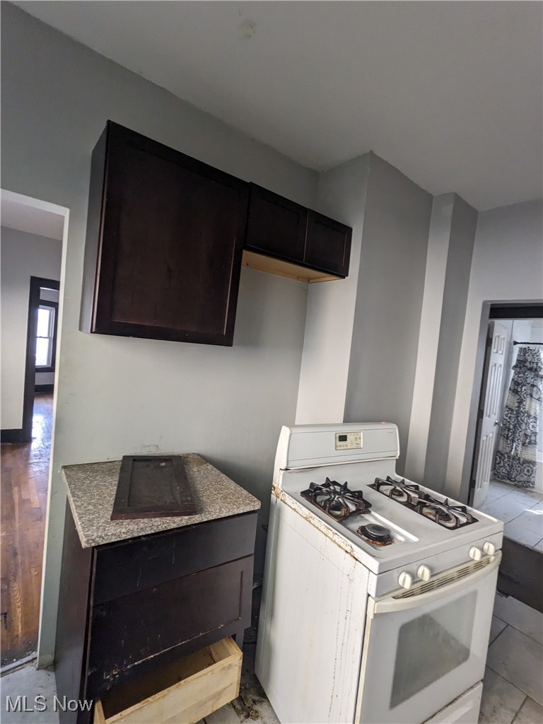 956 Paxton Road Cleveland, OH 44108 - Photo 11 of 15 Kitchen with dark brown cabinets and white gas range oven