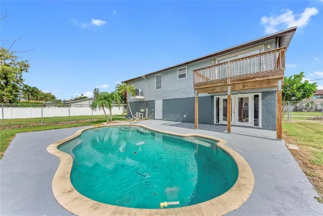 a view of a house with swimming pool and a porch