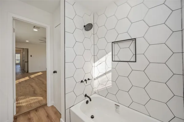 a bathroom with a bathtub and a shower
