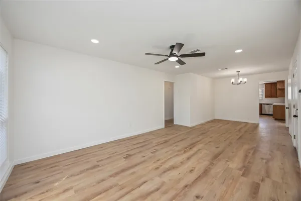 a view of a livingroom with a hardwood floor and a ceiling fan