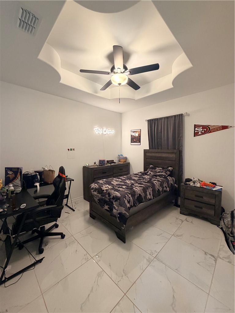 903 West Main Street Alice, TX 78332 - Photo 12 of 24 a bedroom with a bed and a chandelier