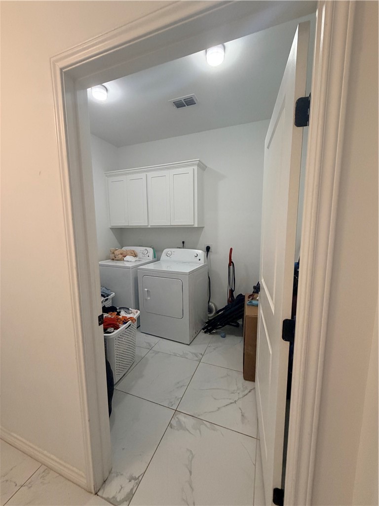 903 West Main Street Alice, TX 78332 - Photo 15 of 24 a utility room with cabinets washer and dryer