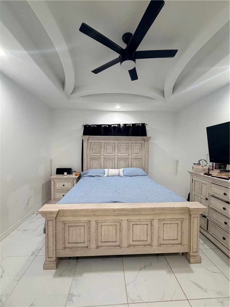 903 West Main Street Alice, TX 78332 - Photo 16 of 24 a bedroom with a bed and ceiling fan