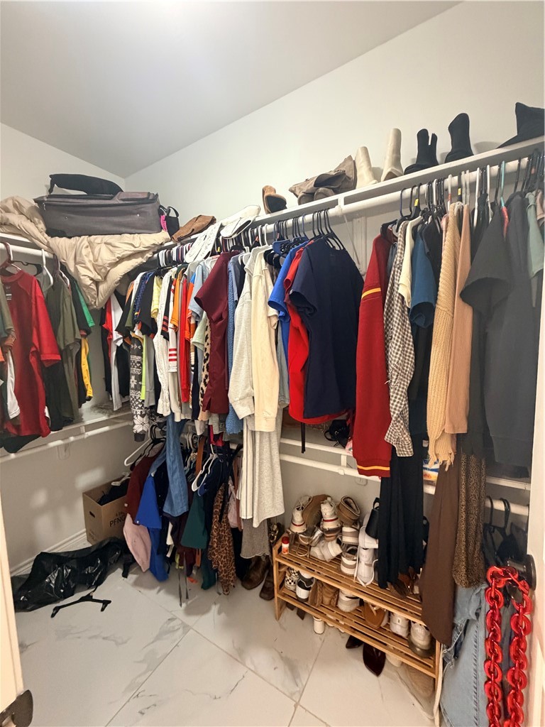 903 West Main Street Alice, TX 78332 - Photo 18 of 24 a view of walk in closet with clothes and shoes