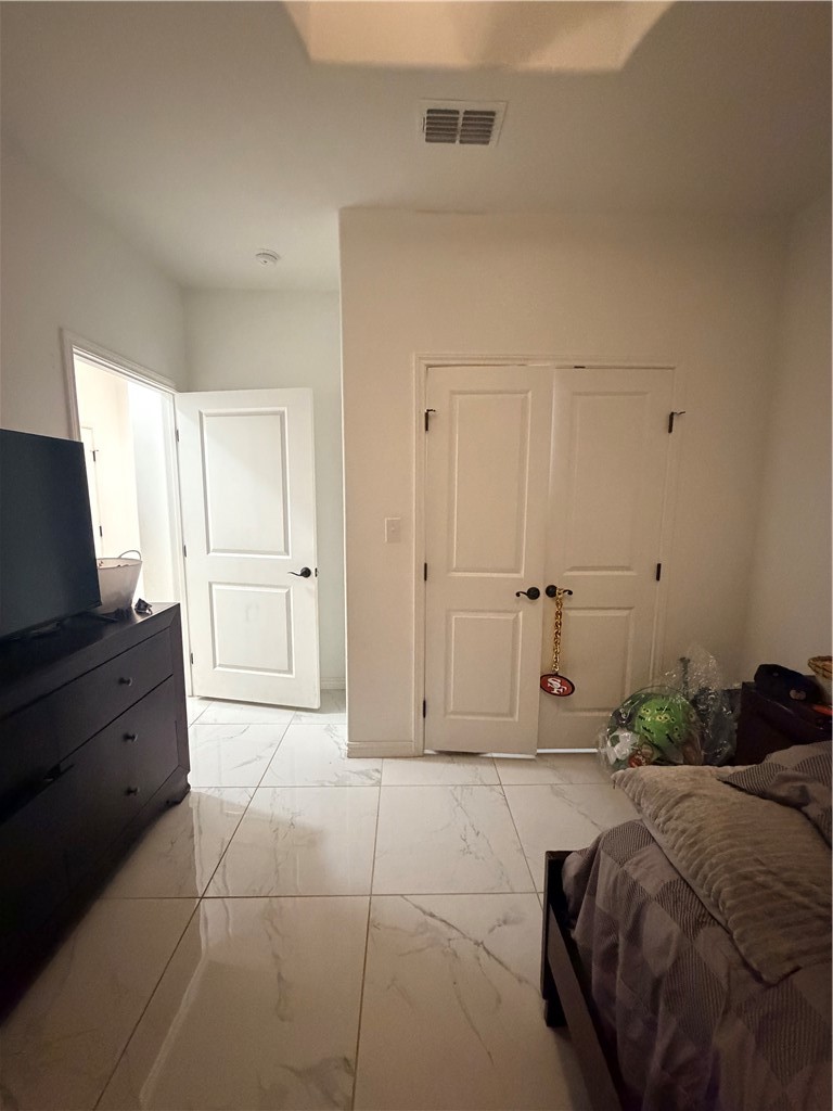 903 West Main Street Alice, TX 78332 - Photo 10 of 24 a spacious bedroom with a bed and a flat screen tv