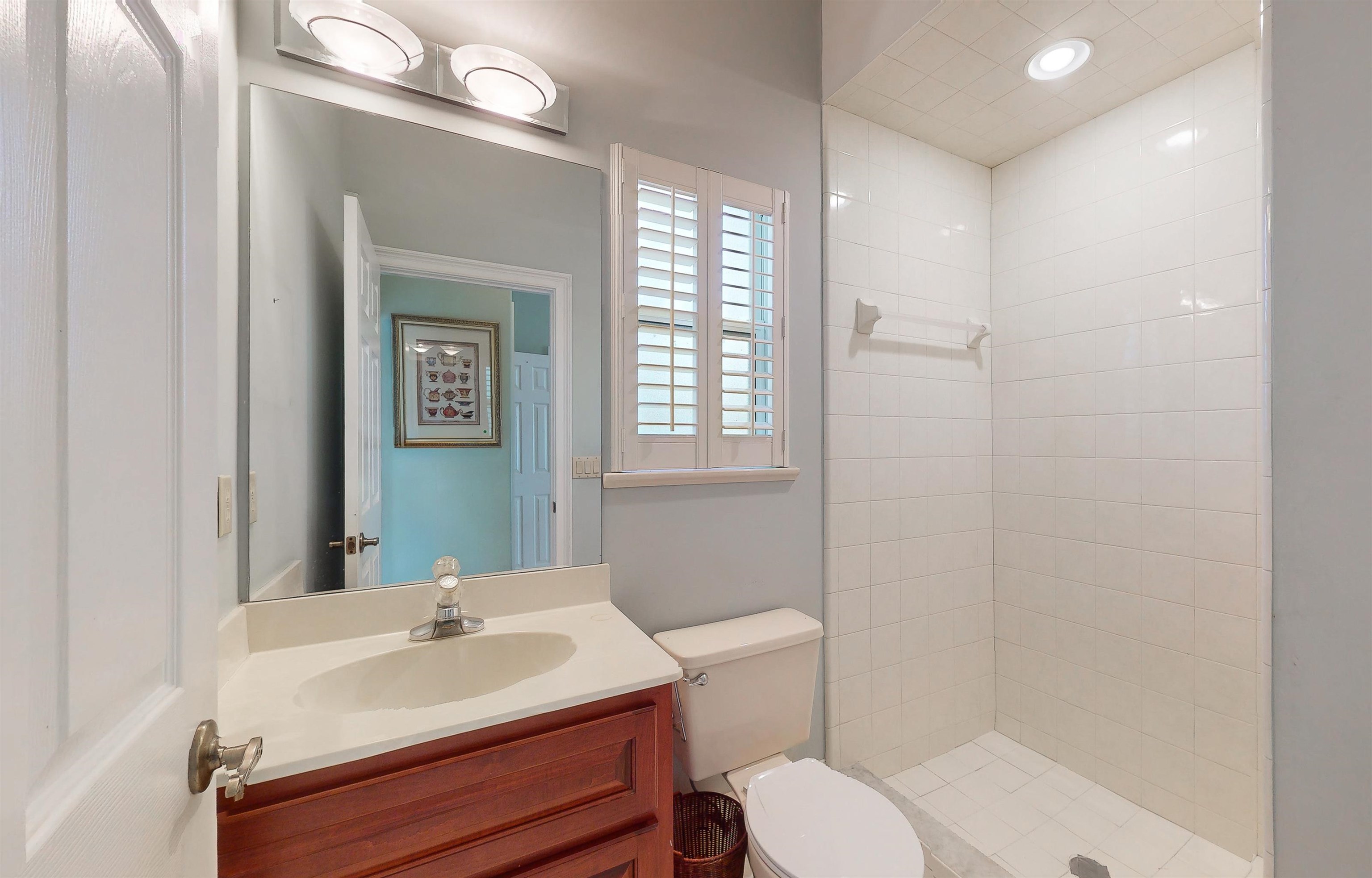 3593 Westover Road Fleming Island, FL 32003 - Photo 26 of 71 a bathroom with a sink toilet a mirror and shower