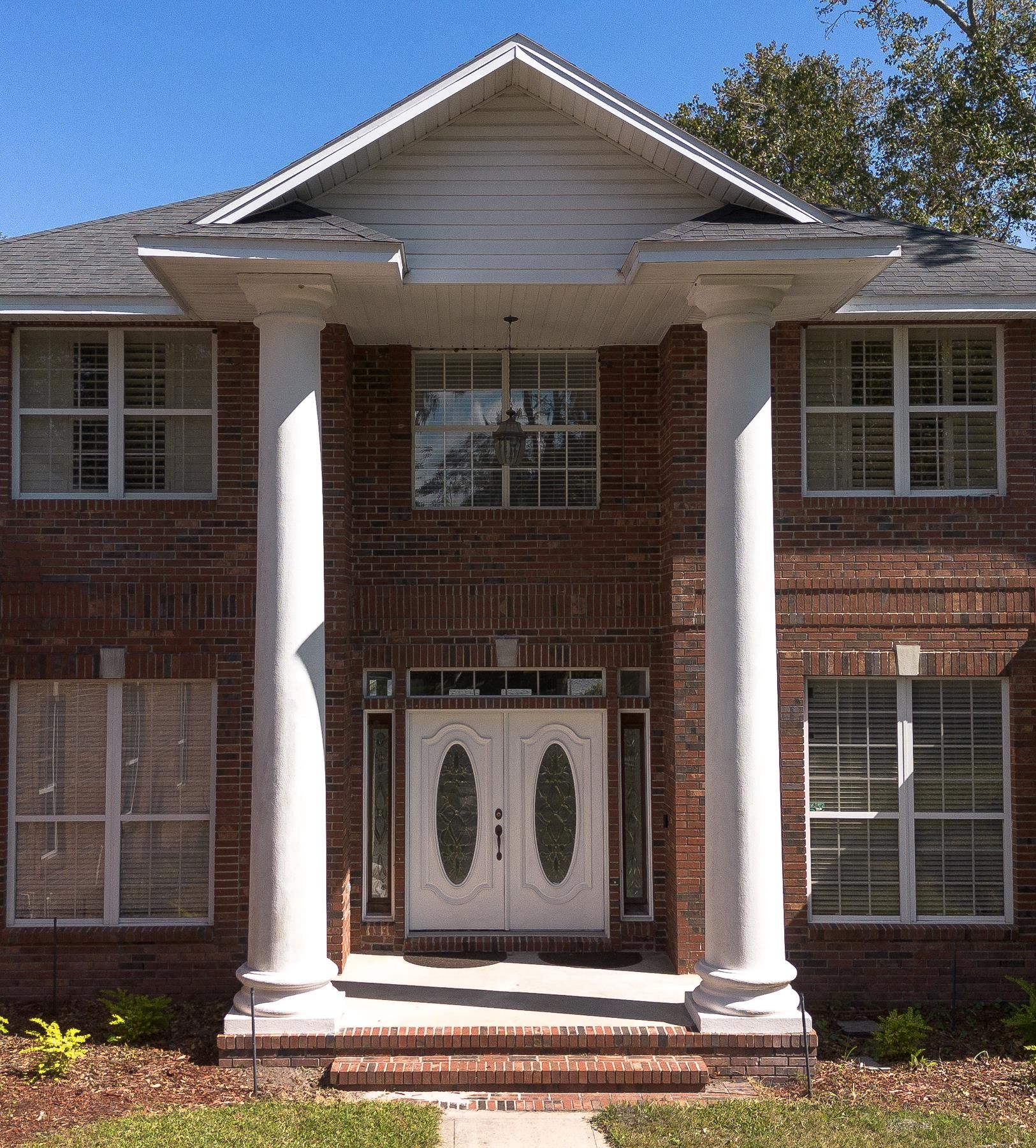 3593 Westover Road Fleming Island, FL 32003 - Photo 6 of 71 a front view of a house with a garden