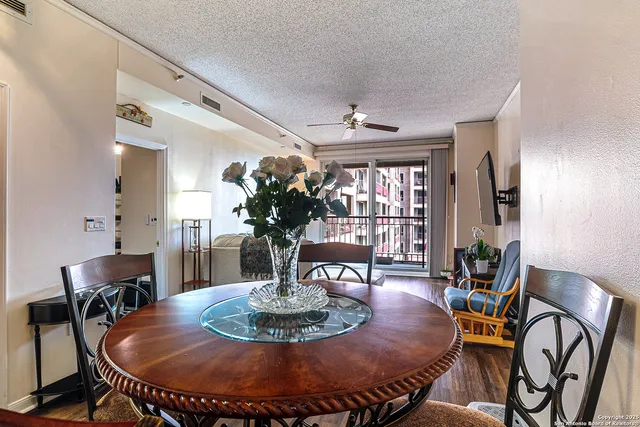 a dining room with furniture a rug and wooden floor