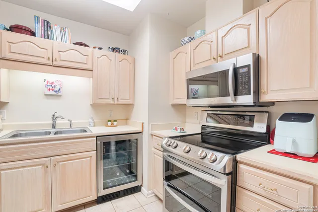 a kitchen with cabinets appliances and a sink