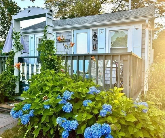a front view of a house with a yard table and chairs