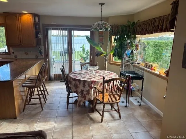 a view of a dining room with furniture window and outside view