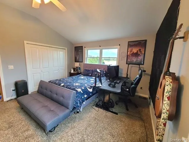 a bathroom with a granite countertop toilet sink and mirror