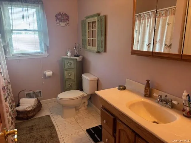 a bathroom with a sink a mirror and a toilet