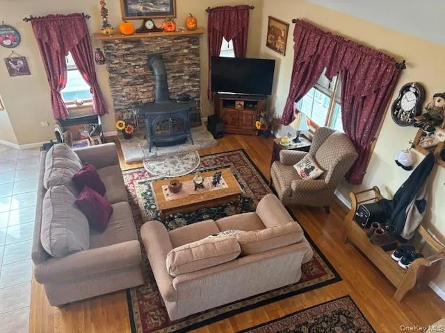 a living room with furniture a fireplace and a flat screen tv