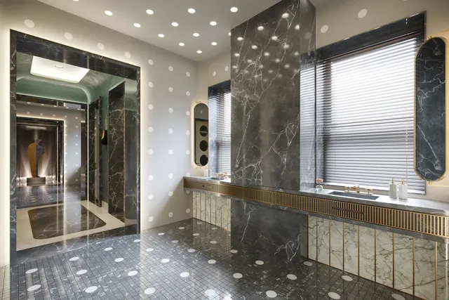 a bathroom with a sink a large mirror and a shower