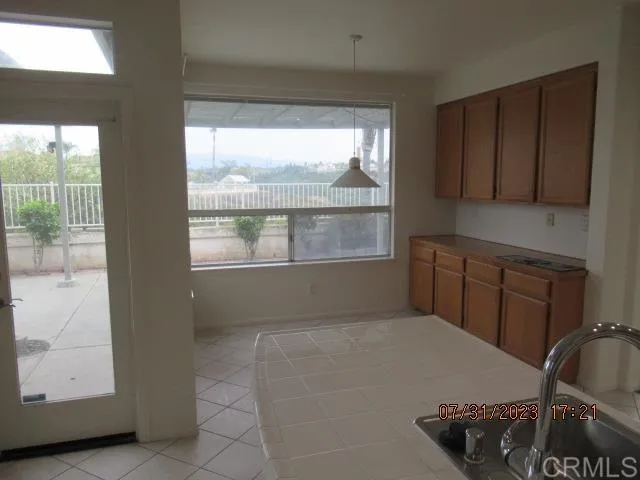 a kitchen with stainless steel appliances kitchen island a stove a sink and a microwave