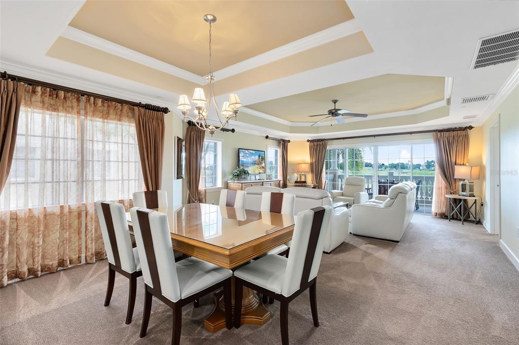1360 Centre Ct Ridge Drive, Unit 201 Reunion, FL 34747 - Photo 15 of 29 a dining room with furniture a chandelier and wooden floor