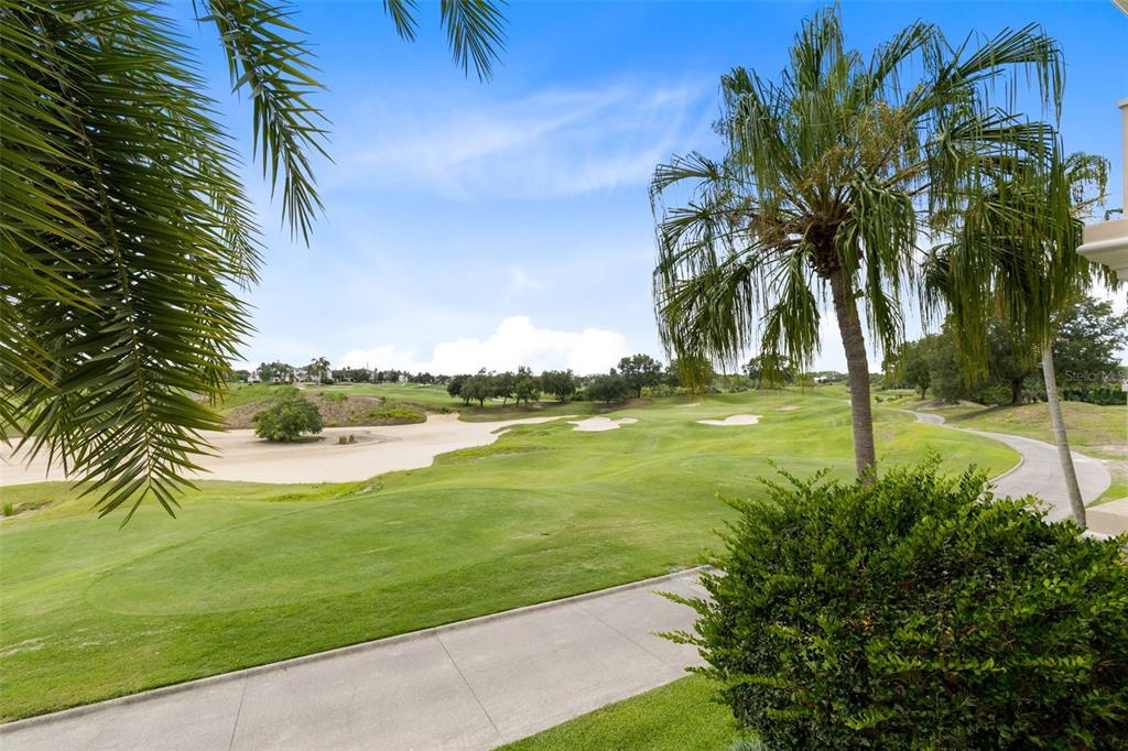 1360 Centre Ct Ridge Drive, Unit 201 Reunion, FL 34747 - Photo 23 of 29 a view of a lake with a yard
