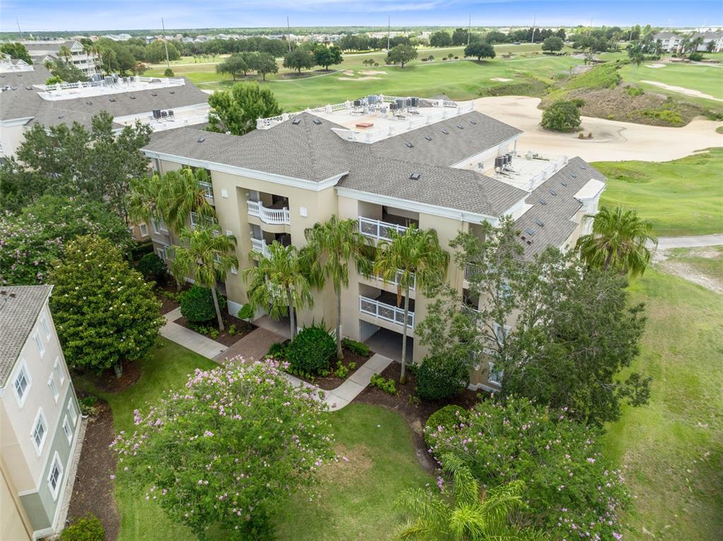 1360 Centre Ct Ridge Drive, Unit 201 Reunion, FL 34747 - Photo 27 of 29 an aerial view of a house with a garden and lake view
