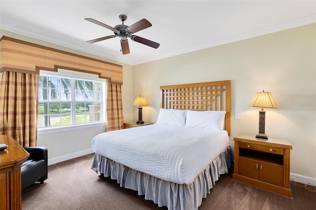 1360 Centre Ct Ridge Drive, Unit 201 Reunion, FL 34747 - Photo 9 of 29 a bedroom with a bed and a lamp on table next to a window