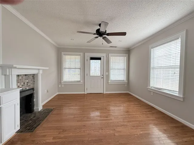 a kitchen with granite countertop a refrigerator and cabinets