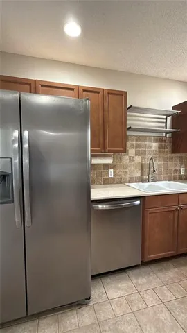 a kitchen with a sink cabinets and window
