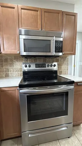 a kitchen with granite countertop a refrigerator and a sink