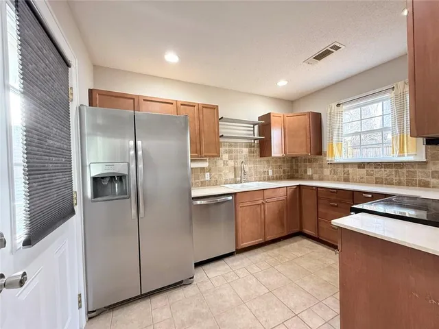 a kitchen with stainless steel appliances granite countertop a sink stove and microwave