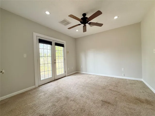 a front view of a house with a wooden deck