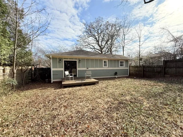 a tree in front of a white house
