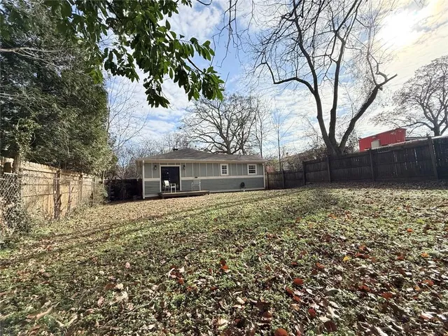 a view of yard with wooden fence