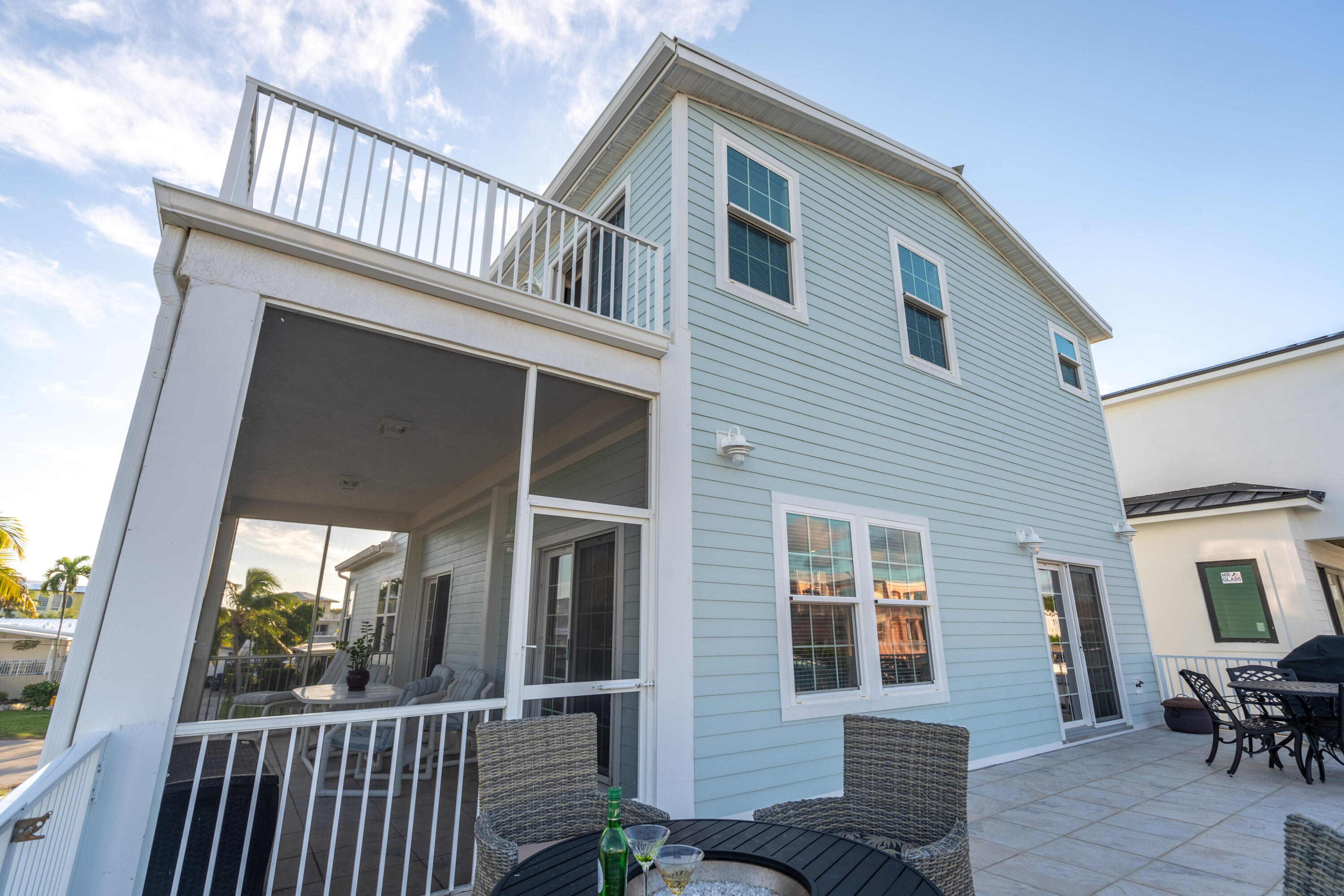 55 Ocean Drive Key Largo, FL 33037 - Photo 20 of 53 a view of a house with porch and wooden floor