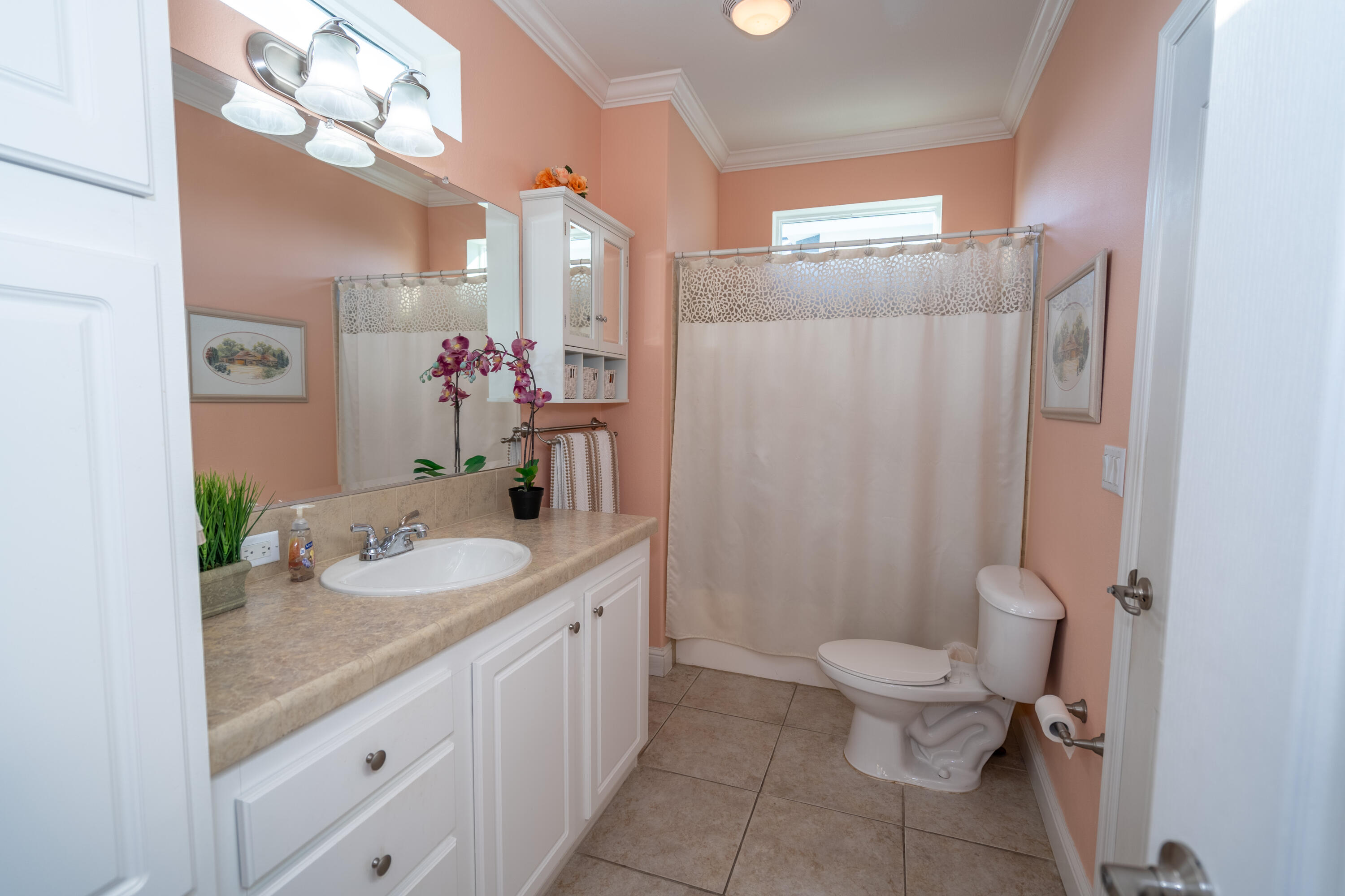 55 Ocean Drive Key Largo, FL 33037 - Photo 22 of 53 a bathroom with a granite countertop sink mirror vanity and toilet