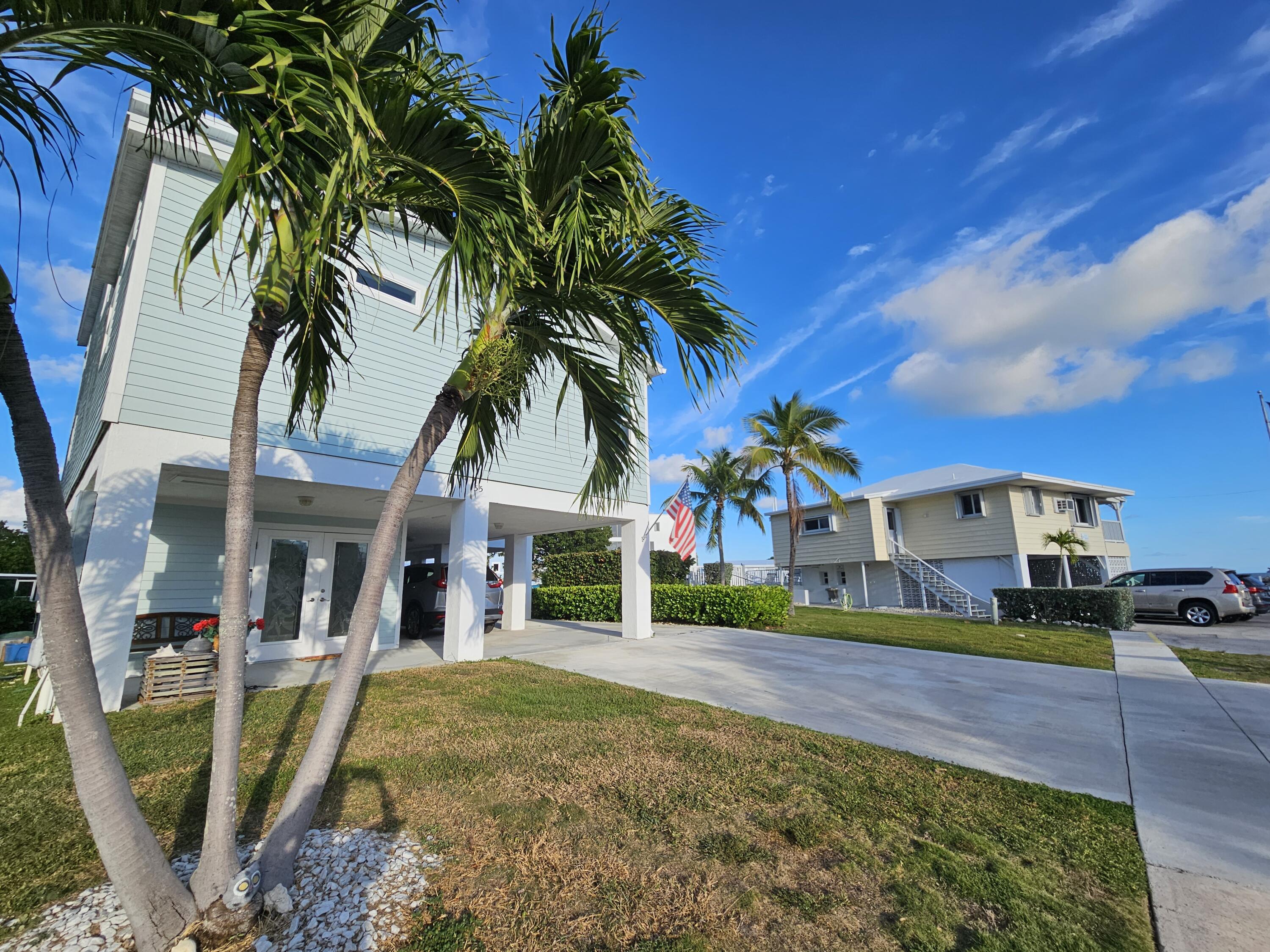 55 Ocean Drive Key Largo, FL 33037 - Photo 40 of 53 a view of multiple houses with a yard