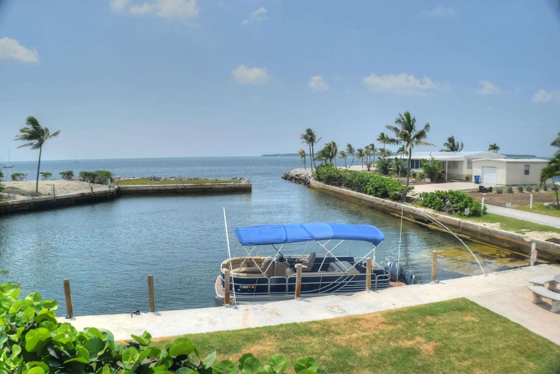 55 Ocean Drive Key Largo, FL 33037 - Photo 49 of 53 a view of a backyard with plants and a patio