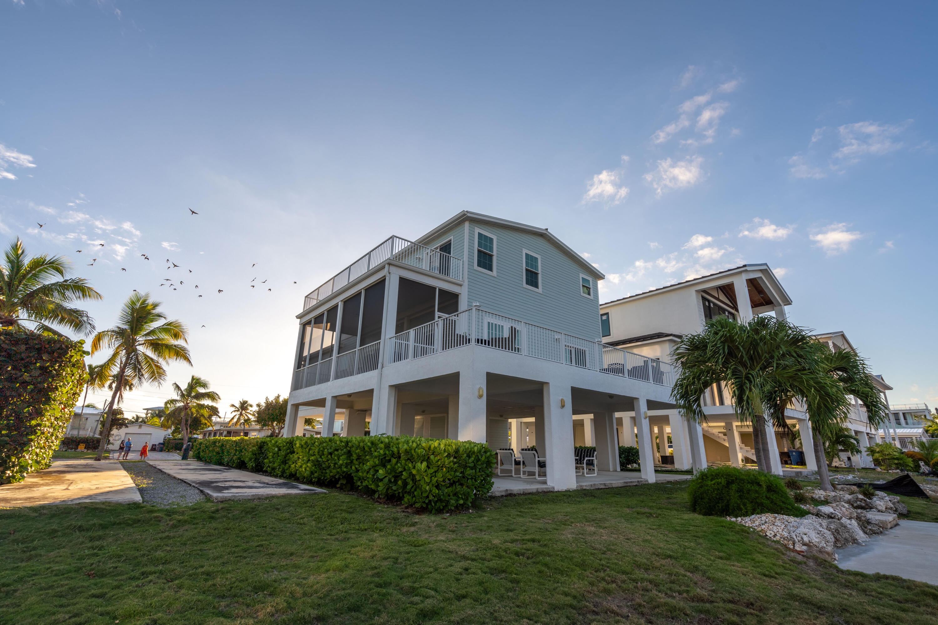 55 Ocean Drive Key Largo, FL 33037 - Photo 6 of 53 a front view of residential houses with yard and green space