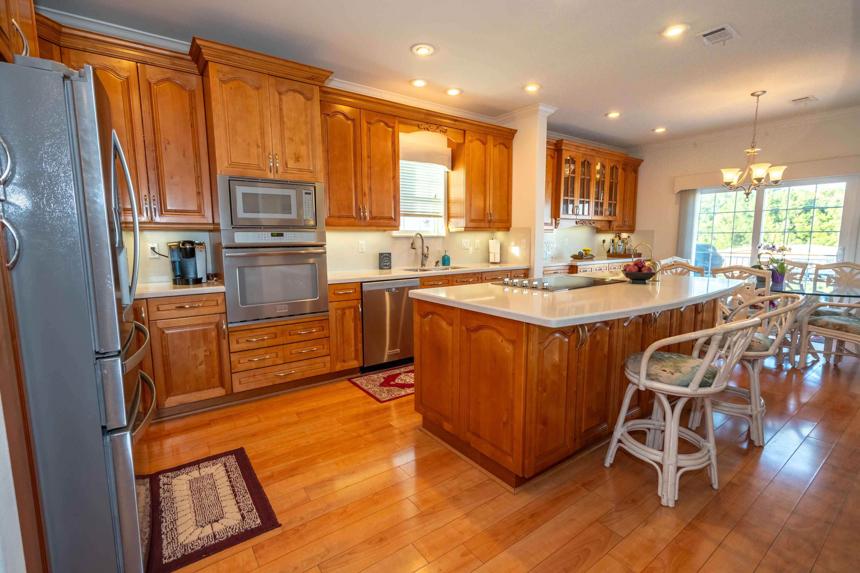 55 Ocean Drive Key Largo, FL 33037 - Photo 10 of 53 a kitchen with wooden cabinets and center island