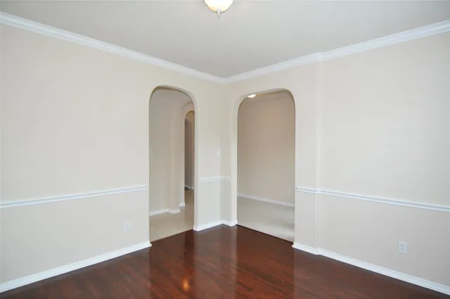 an empty room with wooden floor and a window
