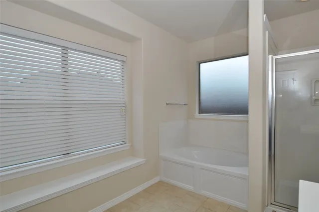 a bathroom with a bathtub and a shower