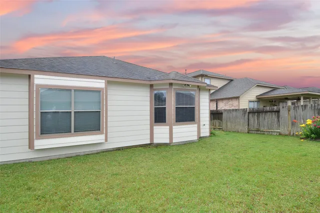 a view of a house with a garden and yard